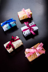 Gifts basket and candle against black background