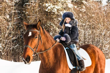 Foto op Canvas Small girl and horse in a winter © keleny