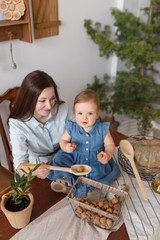 daughter and mother happy in the kitchen holding a walnut