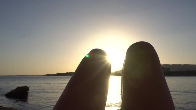 Legs of Woman Against a Golden Sunset