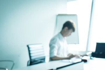 blur background of business man working in meeting room with smart phone