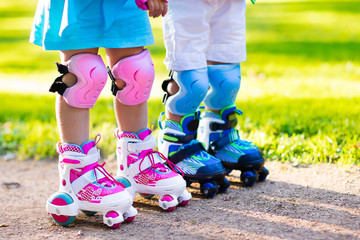 Kids roller skating in summer park