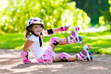 Little girl with roller skate shoes in a park