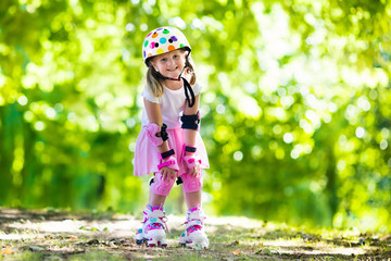 Little girl with roller skate shoes in a park