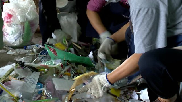 People sorting garbage for recycling
