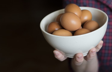 woman holding a bowl of eggs