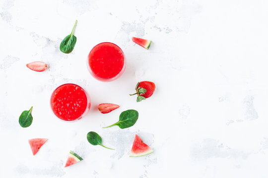 Summer cocktail with watermelon and strawberry on white background. Top view, flat lay