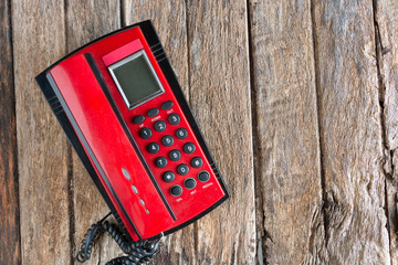 red telephone on wood background old style