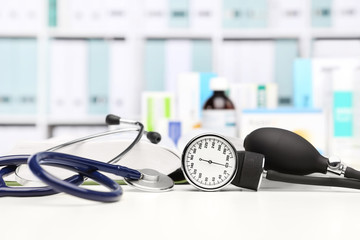 doctor desk with medical equipment, stethoscope and clinic tonometer, blood pressure measurement,...