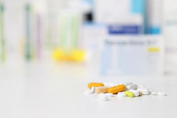 pills and medicine capsule on table, drugs and tablets boxes  in background