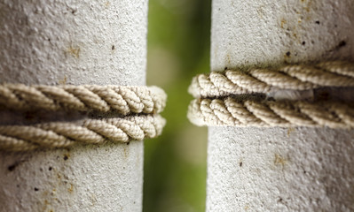 rope circle on the metal pole, tied rope on the pole close up. 2 poles with 2 ropes. Selective focus