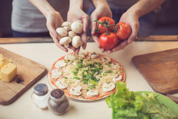 Young couple cooking in kitchen