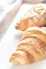Croissants on the white plate: top view