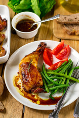 Caramelized baked chicken legs with green beans