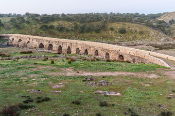 Fototapeta na wymiar Ancient Roman bridge over the Salor river, located near Aliseda. Extremadura. Spain.