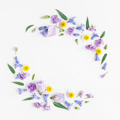 Naklejka na ściany i meble Flowers composition. Wreath made of various colorful flowers on white background. Flat lay, top view