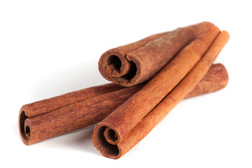 three cinnamon sticks isolated on white background