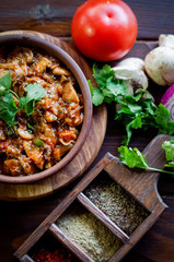 Georgian Satsivi with mushrooms onions and tomatoes in a clay plate