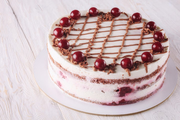 Chocolate cake with mousse, decorated cherries