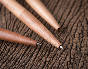Ballpoint wooden pen on wood background