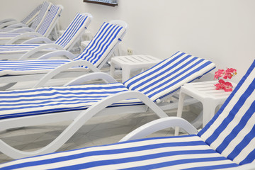 Chaise-longues in a fitness-hall, spa or so on