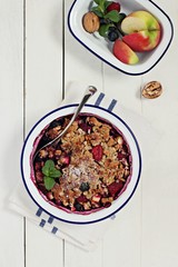 Apple-berry crumble with oatmeal and nuts crunch. Clean eating concept.Rustic style.
