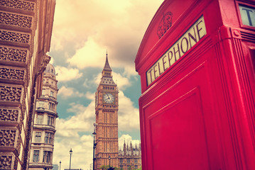 Fototapeta na wymiar London - Big Ben tower and a red phone booth. Vintage film filter. Instagram filter.