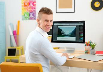 Young male designer at workplace