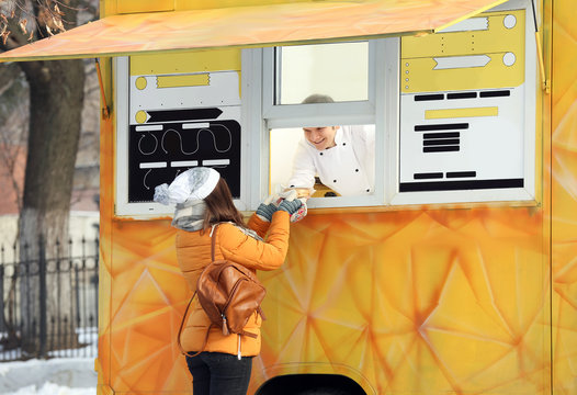 Young girl buying meal at food truck cafe