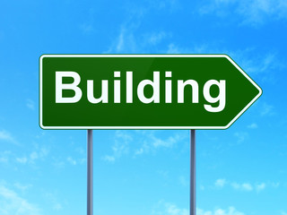Building construction concept: Building on road sign background