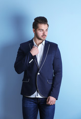 Handsome young man on color background