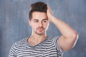 Handsome young man on color background