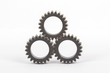 Small group of gears with their teeth engaged on a white background.