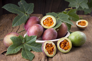 assion fruit and its pulp on a wooden background, fruit originating in the south of America.

