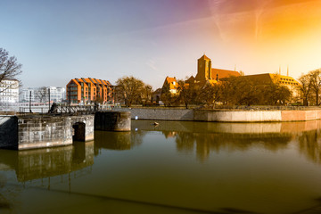 Obraz premium View on Church of the Holy Cross and St. Bartholomew, Odra river and Tumski Island, Wroclaw, Poland. Beautiful winter landscape.