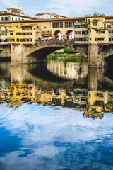 Deurstickers Ponte Vecchio Bridge Reflecting on River Arno in Florence, Italy © Giorgio Magini