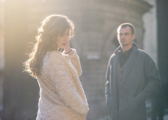 Handsome groom and his beautiful sensual bride on the street on sunset. Close-up portrait.