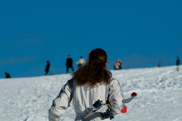 Woman going on hill to ski