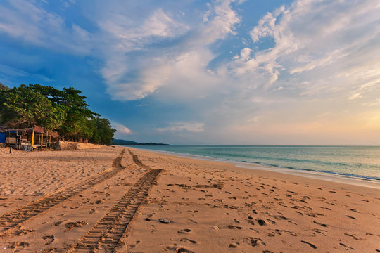 Fototapeta Tropical beach at sunset.