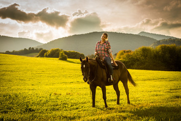 Girl with a blue and red mapped shirt with a horse in Slovakia