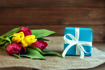 Tulips and gift. Greeting. Concept of holiday, birthday, Easter, March 8.
