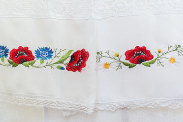 Embroidered floral pattern on a white linen towel