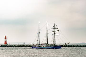 Sailing ship on the sea. Tall Ship and lighthouse Yachting travel.