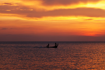 Naklejka na ściany i meble Fishing boat at beautiful sunset
