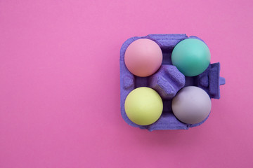 Easter eggs box on pink background