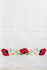 Embroidered floral pattern on a white linen towel