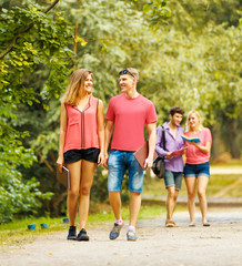 group of happy students in a Park on a Sunny day