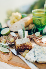 Served table for romantic lunch with two green glasses outdoor