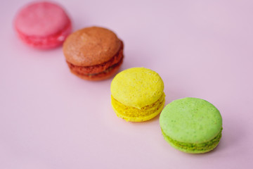 colorful macaroons on the pink background