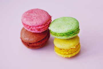 colorful macaroons on the pink background